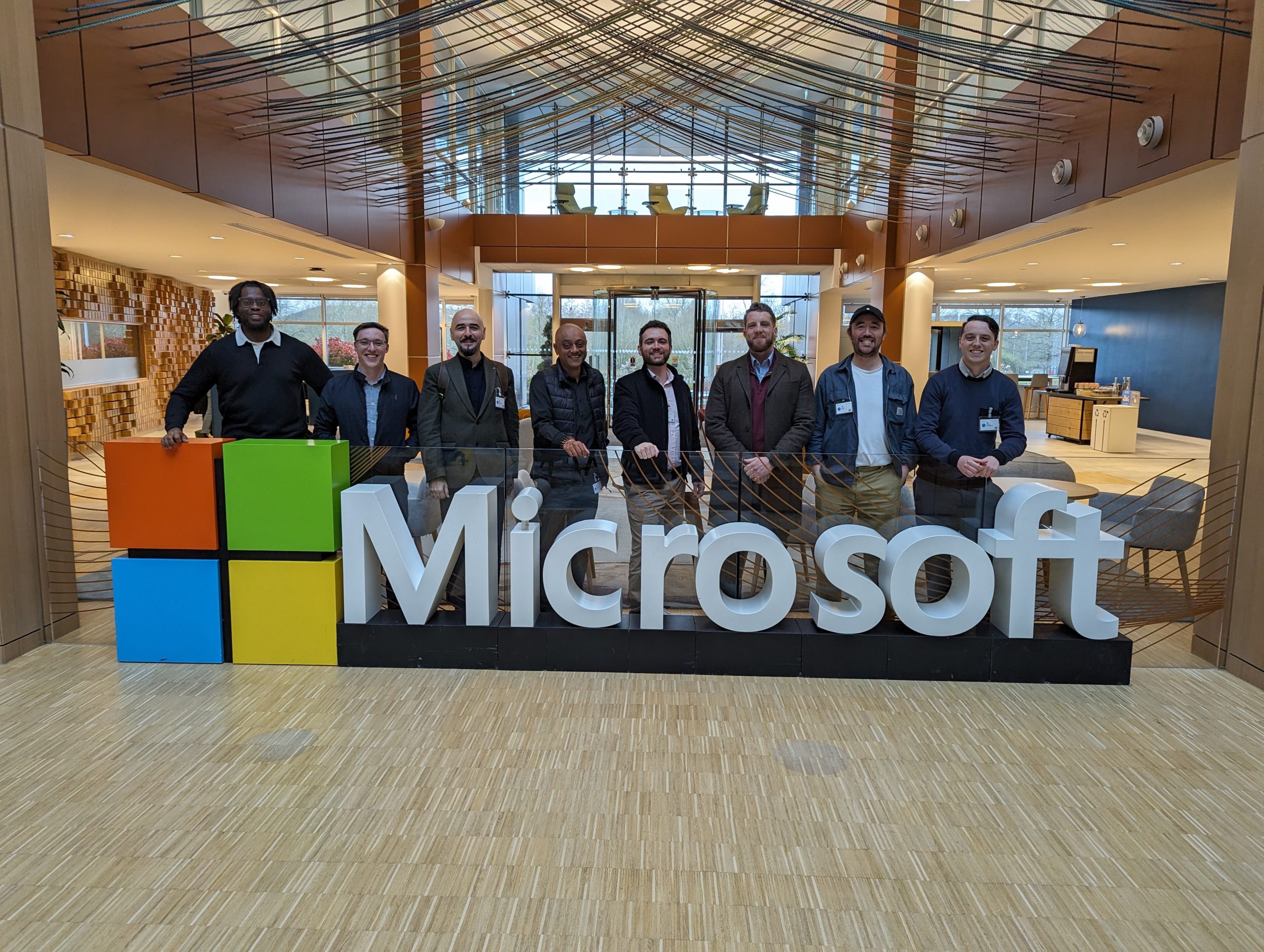 people standing behind a microsoft sign